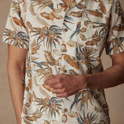 Short sleeve linen cotton camp shirt in Sugar Almond featuring bold tropical print and camp collar design.