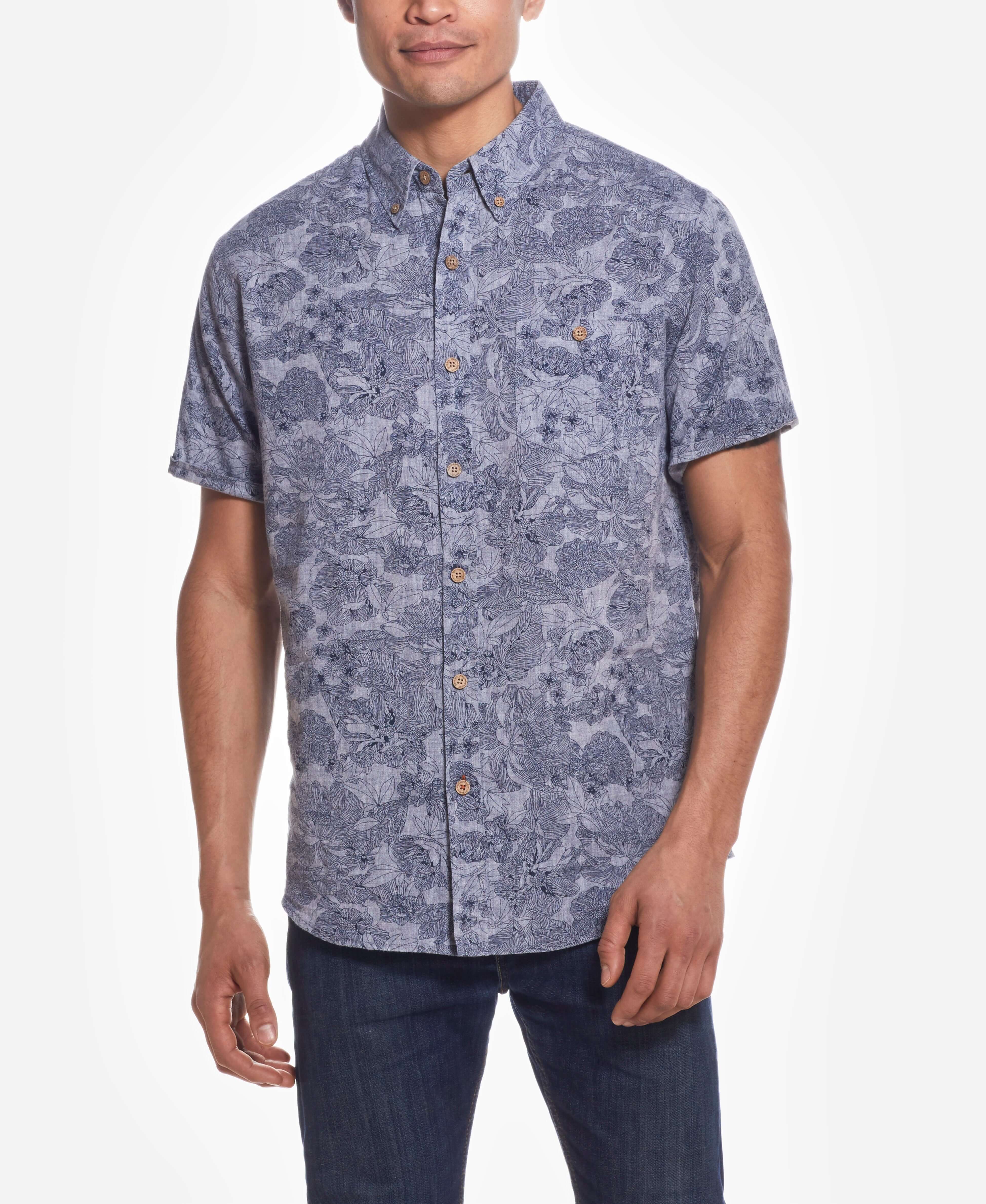 Short Sleeve Linen Cotton Floral Print In Bering Sea shirt worn by a model, showcasing casual style with a floral design.