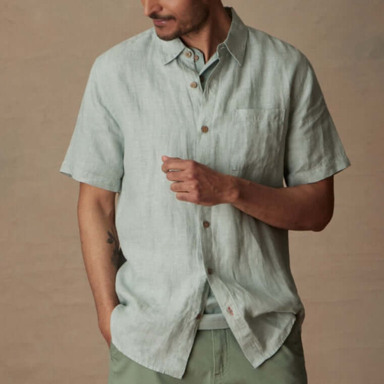 Short sleeve teal mist linen shirt with front pocket and button closure on model