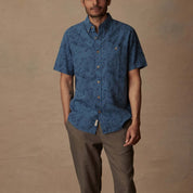 Short sleeve blue ashes linen cotton shirt with abstract print on model for relaxed summer style.