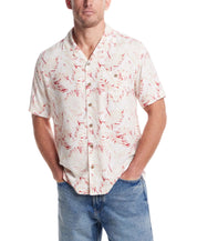 Short sleeve rayon printed camp shirt in dusty pink with retro pattern, styled with relaxed fit and denim.
