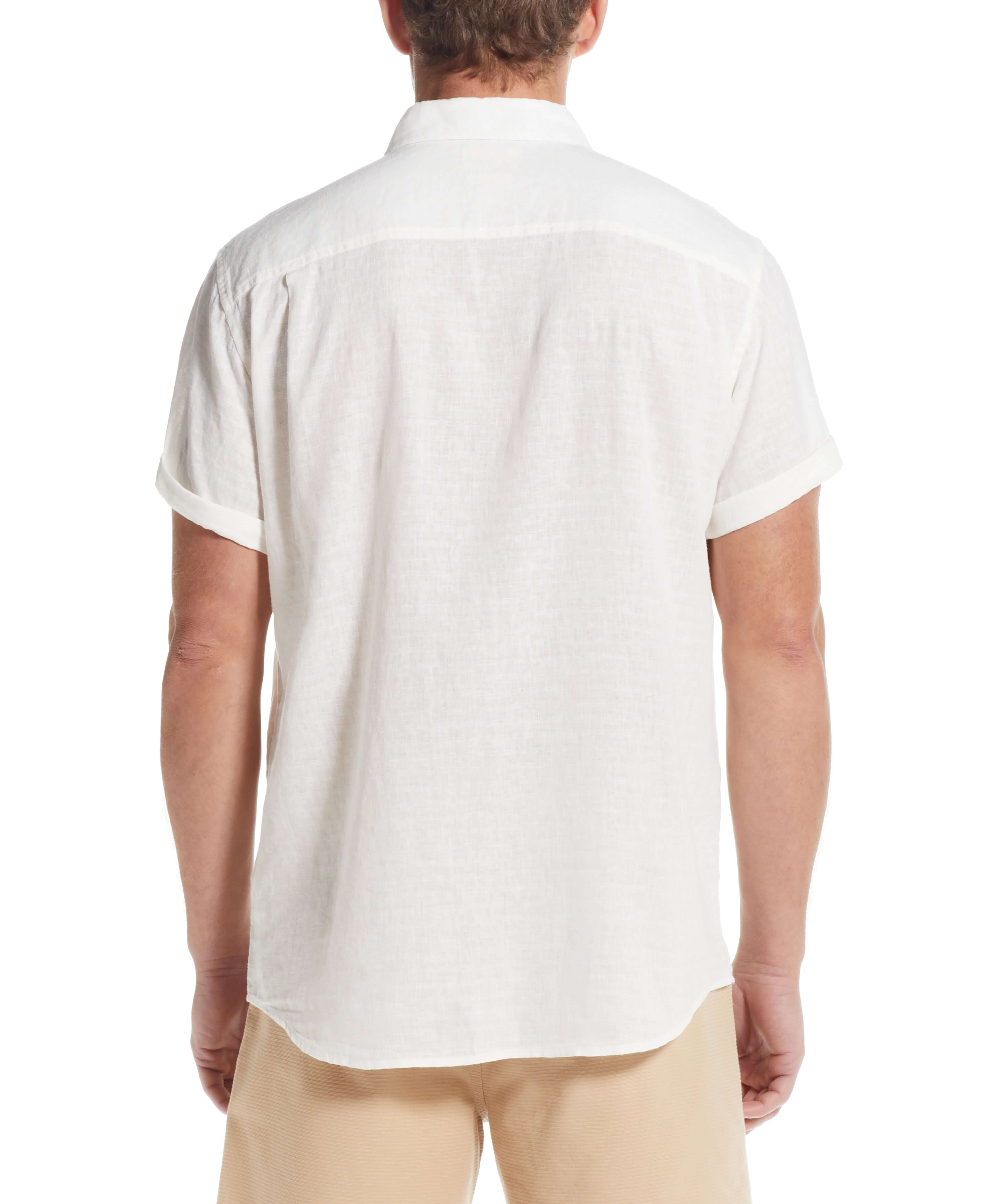 Back view of a man wearing a short sleeve solid linen cotton shirt in bright white.