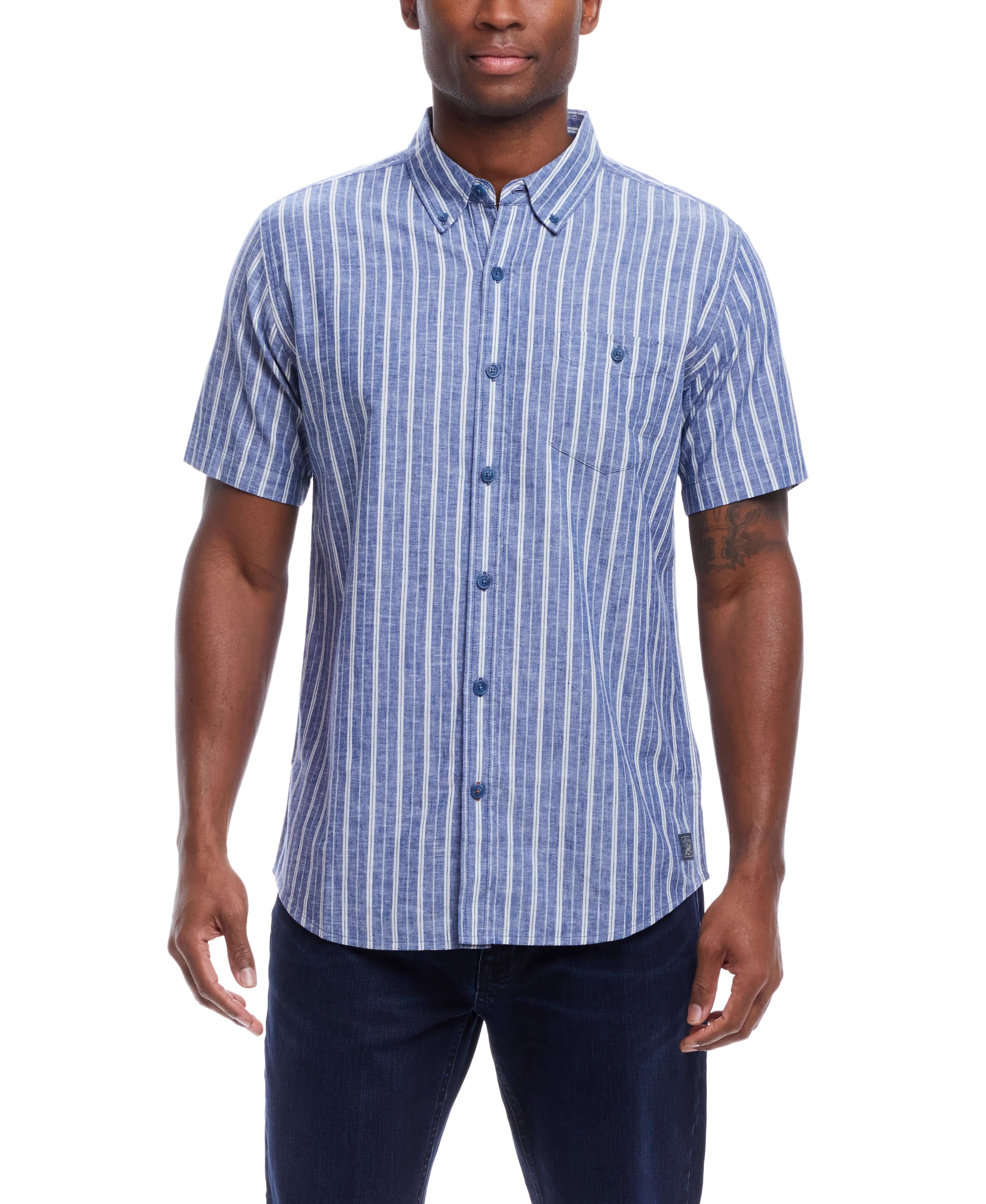 Short Sleeve Striped Cotton Button Down Shirt In Monaco Blue worn by a model, featuring a button down collar and chest pocket.