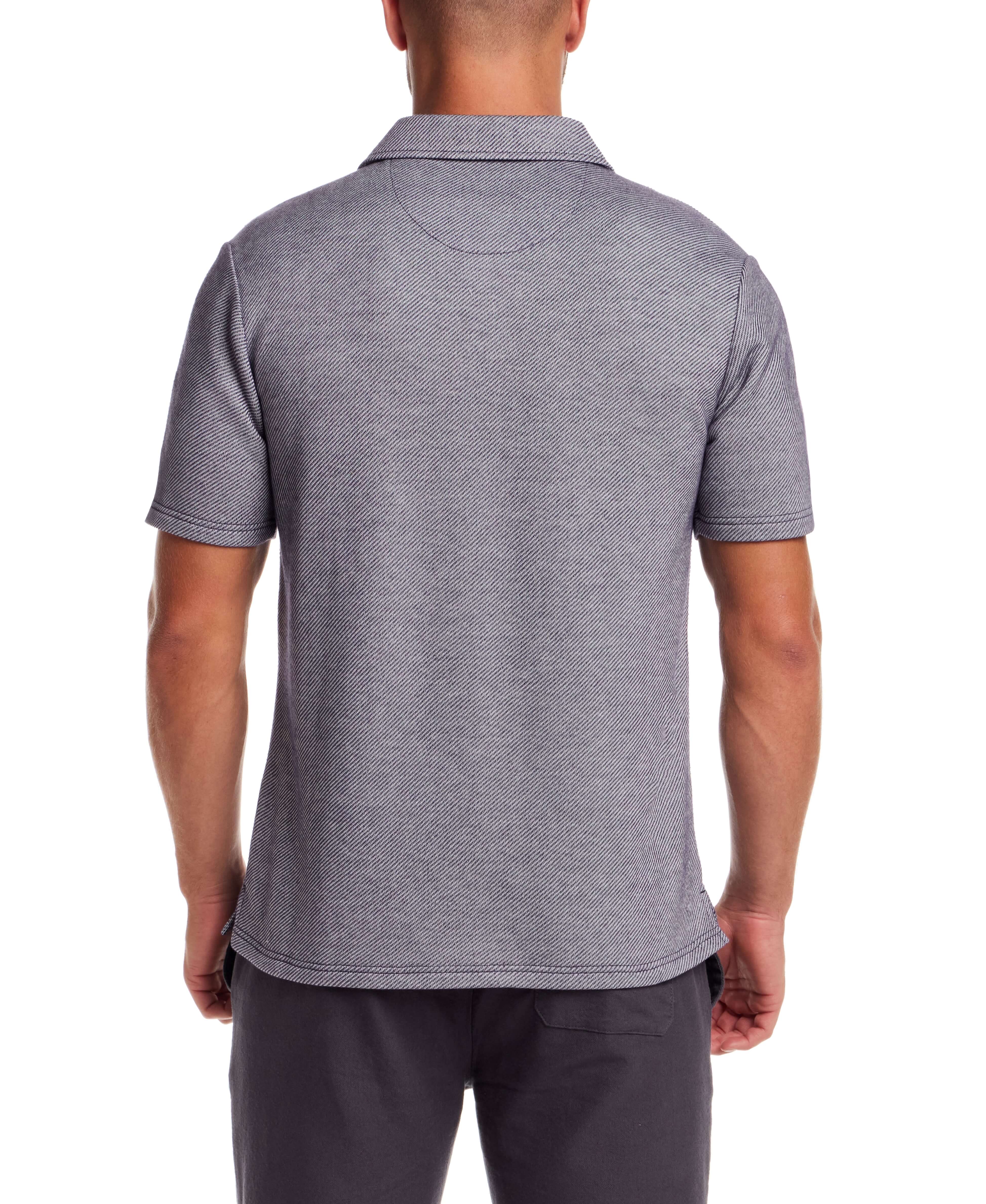 Back view of a man wearing a short sleeve twill polo in Peacoat Navy with a polo collar and chest pocket.