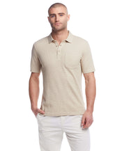 Short sleeve waffle polo in bleached sand featuring a classic fit, 3 button placket, and chest pocket.