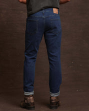 Back view of slim fit denim jeans in Carolina blue, showcasing a comfortable stretch fit and tailored design.