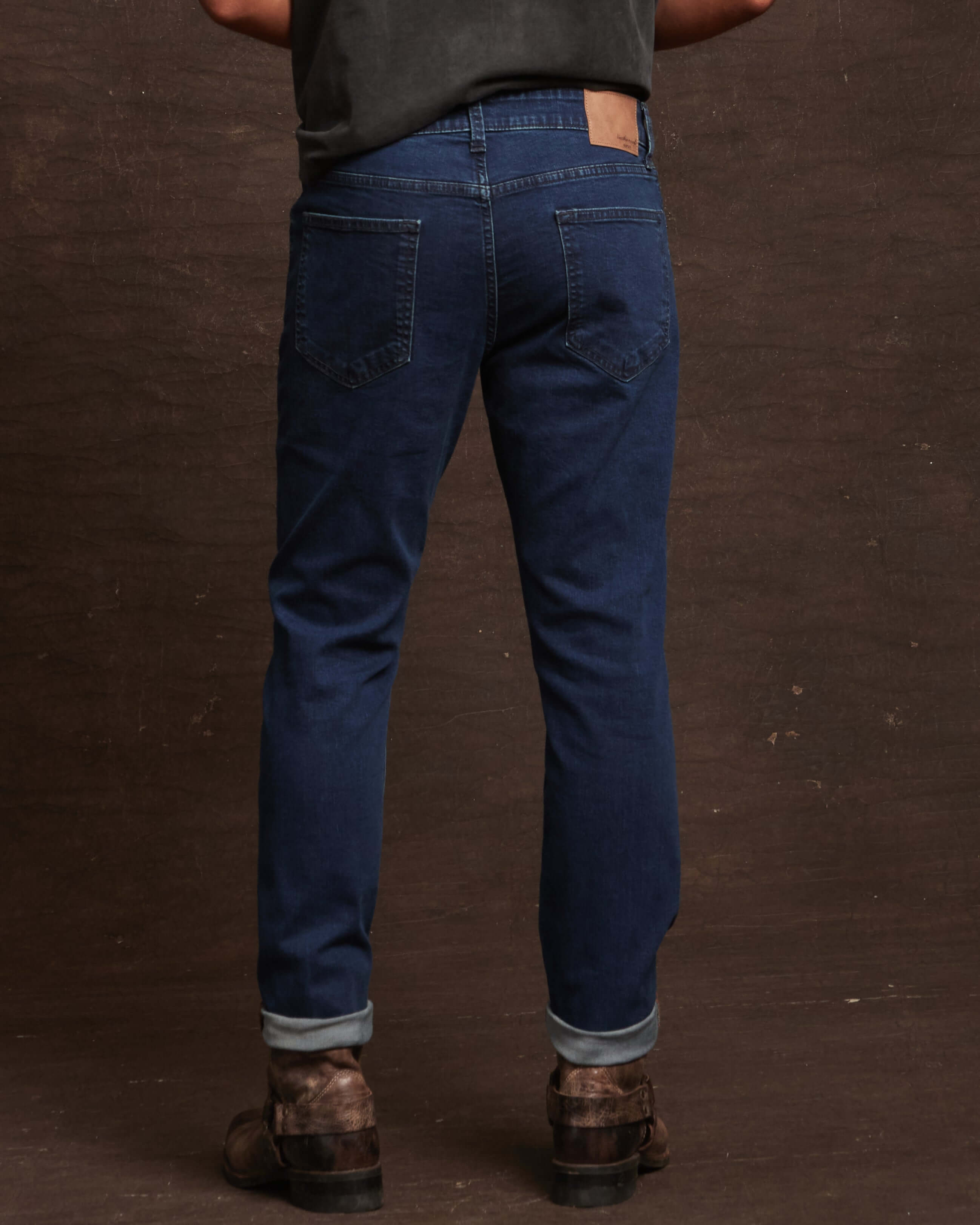 Back view of slim fit denim jeans in Carolina blue, showcasing a comfortable stretch fit and tailored design.