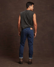 Man wearing slim fit denim jeans in Carolina blue, showcasing the back view with a comfortable and stylish look.