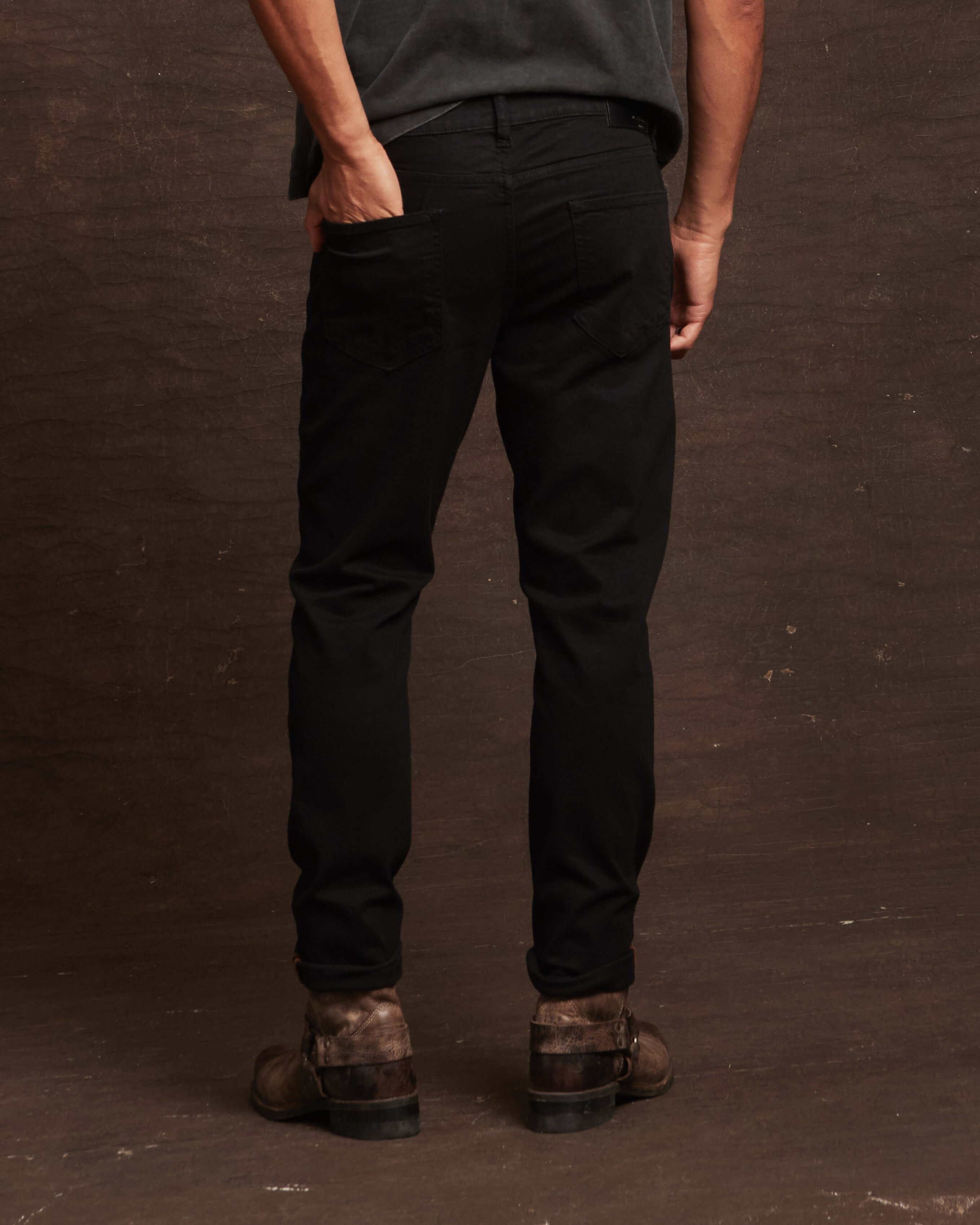 Slim fit jet black denim jeans showcasing a comfortable stretch fit, designed for a polished look from the back.