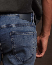 Close-up view of slim fit denim jeans in Niagara showing back pocket and waistband, highlighting comfort and stretch fit.