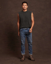 Slim fit denim jeans in Niagara on a model, paired with a sleeveless top and stylish boots, showcasing comfort and style.