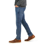 Slim fit denim jeans in Niagara with All-Way stretch, paired with a gray sweater and brown shoes.