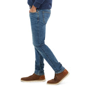 Slim fit rocker blue denim jeans showcasing all-way stretch and comfort, styled with brown shoes and a casual top.