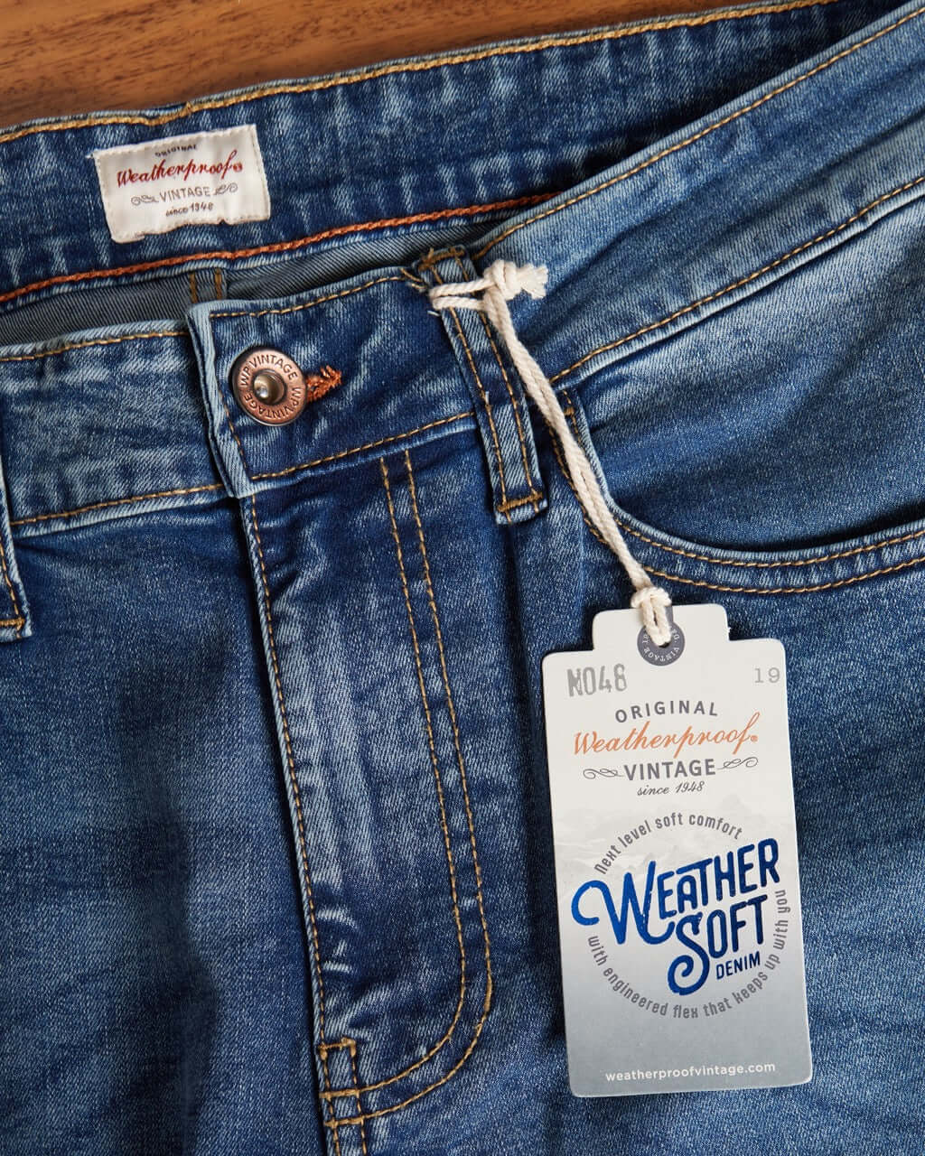 Close-up of slim fit Rocker Blue denim jeans featuring Weather Soft denim tag and button detail.