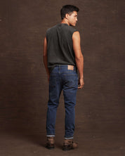 Stylish man wearing slim fit soft blue denim jeans, showcasing the back view and straight fit design.