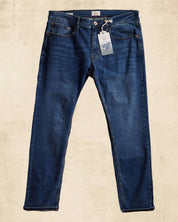 Slim fit denim jeans in dark blue, featuring label and casual design for stylish comfort.