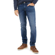 Slim fit soft blue denim jeans with all-way stretch for comfort, styled with brown shoes for a casual look.