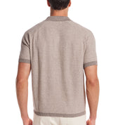 Rear view of a man wearing a striped Johnny collar polo sweater in brown twist with ribbed cuffs.