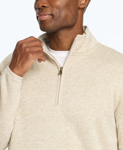 Man wearing a stone-colored sweaterfleece pullover with sherpa trim and quarter zip, showcasing style and warmth.