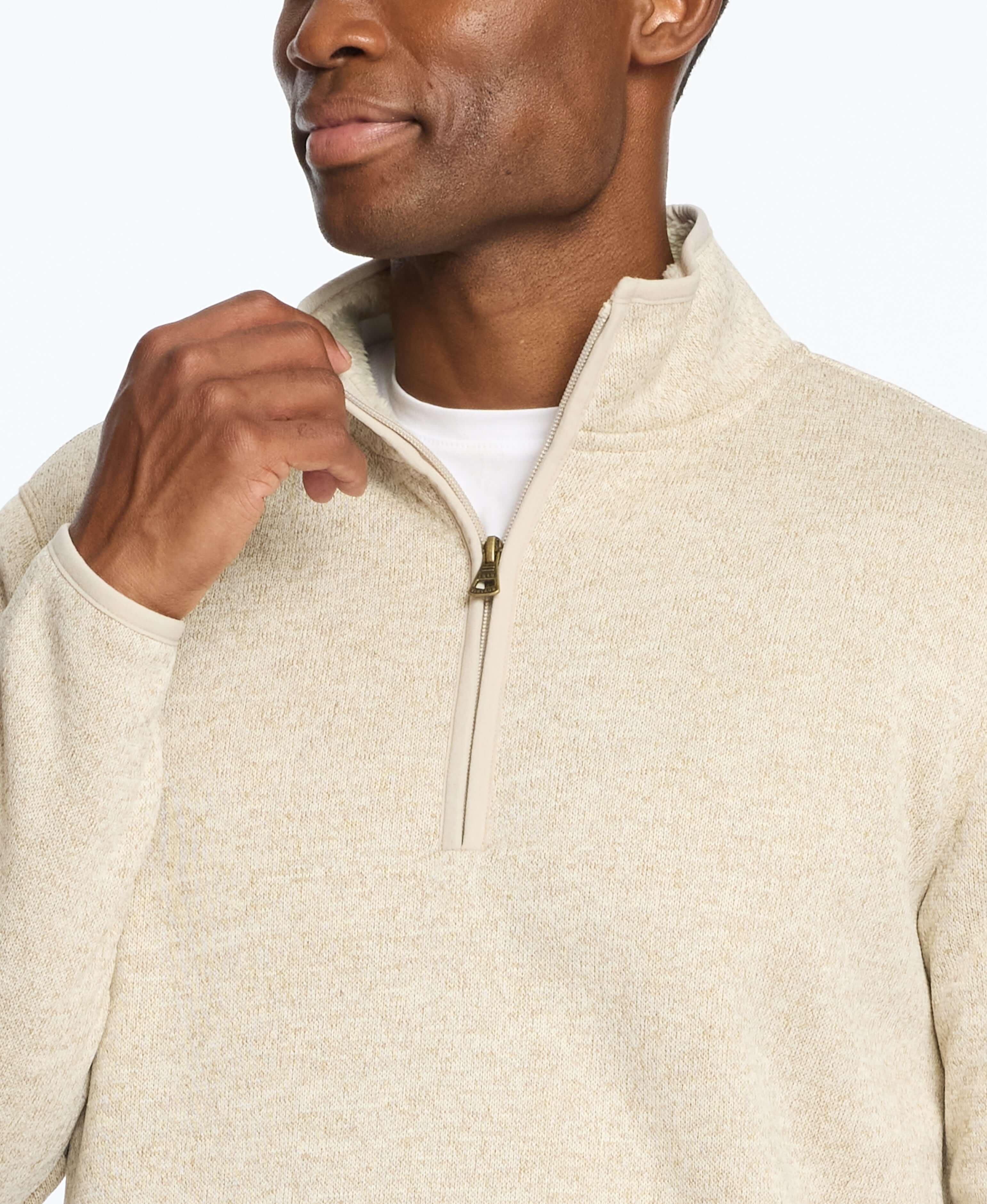 Man wearing a stone-colored sweaterfleece pullover with sherpa trim and quarter zip, showcasing style and warmth.