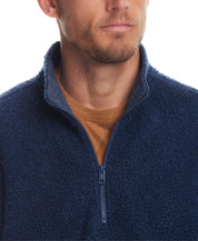 Close-up of a man in a Teddy Sherpa Pullover featuring a quarter zip in Pageant Blue, showcasing its plush fleece texture.