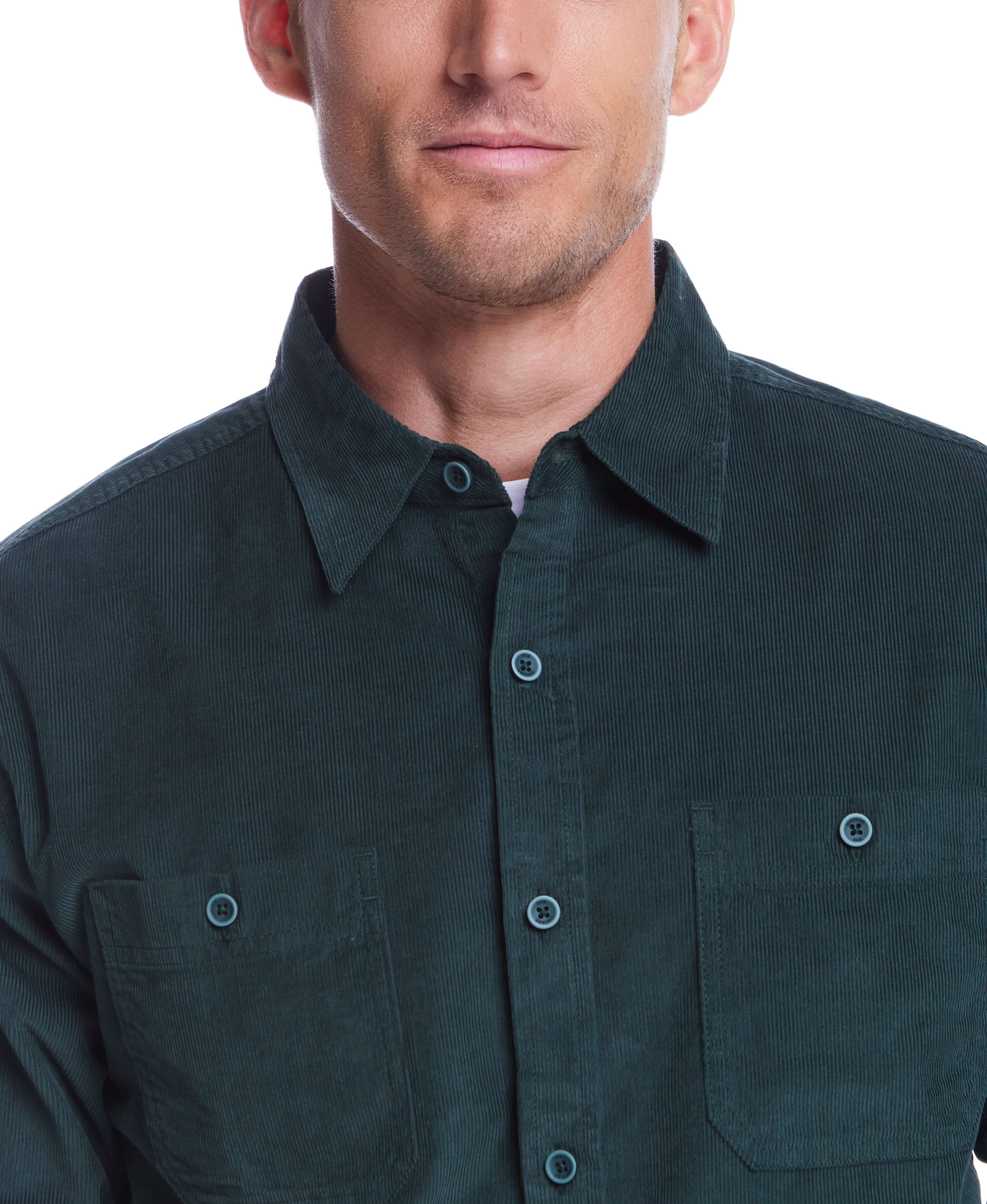 Model wearing a thin wale solid cord shirt in scarab color, featuring a button-down collar and two chest pockets.