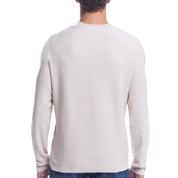 Back view of the Twill Stonewash Sweater in Natural, showcasing its airy texture and classic roll-neck design.
