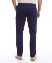 Back view of a man wearing Cargo Pant In Navy with adjustable draw cord and side pockets.