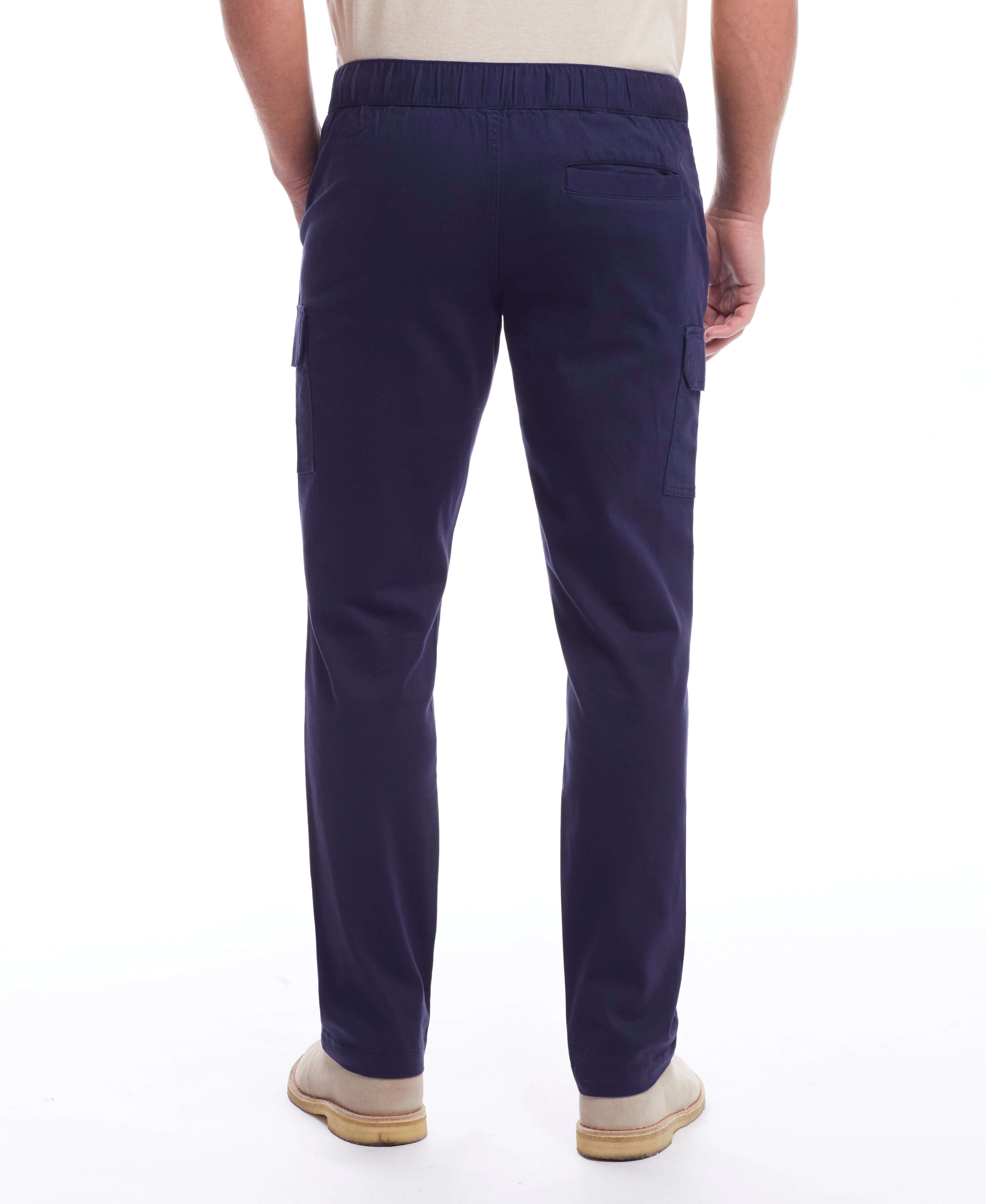 Back view of a man wearing Cargo Pant In Navy with adjustable draw cord and side pockets.