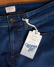 Close-up of Weatherproof Vintage denim jeans with tag, showcasing the premium material and craftsmanship.