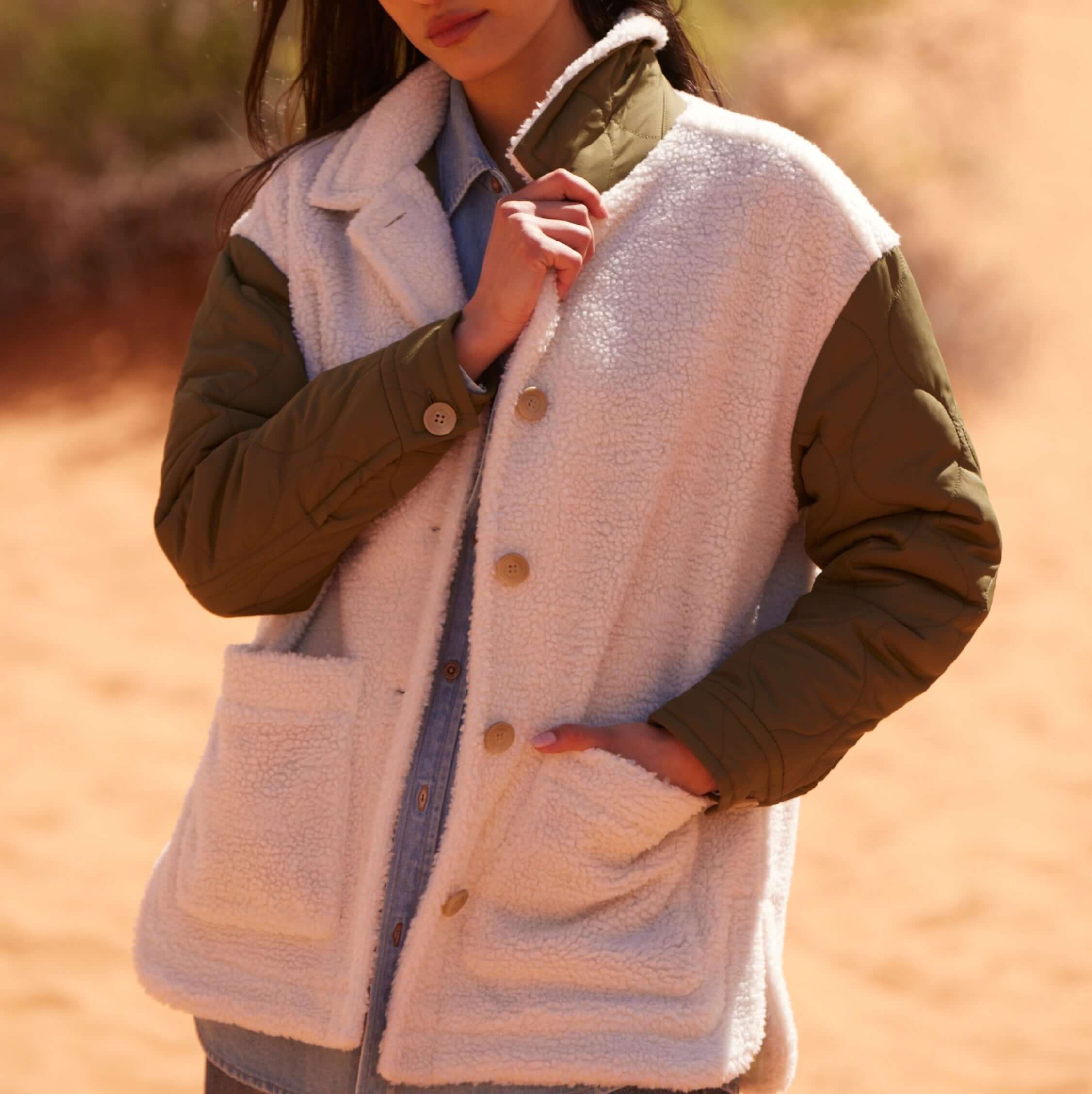 Women's mixed media quilted jacket in green and white, featuring faux shearling and onion quilted sleeves.