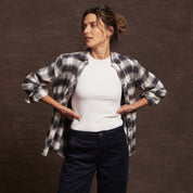 Model showcasing Women's Stretch Flannel in Black, featuring cozy cotton fabric and classic fit with rolled sleeves.
