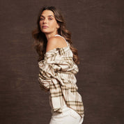 Model showcasing a Women's Stretch Flannel in Green, featuring a cozy plaid design and casual off-shoulder style.
