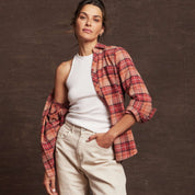 Model wearing a women's orange stretch flannel with a notch V-neck and rolled sleeves, showcasing a cozy classic fit.