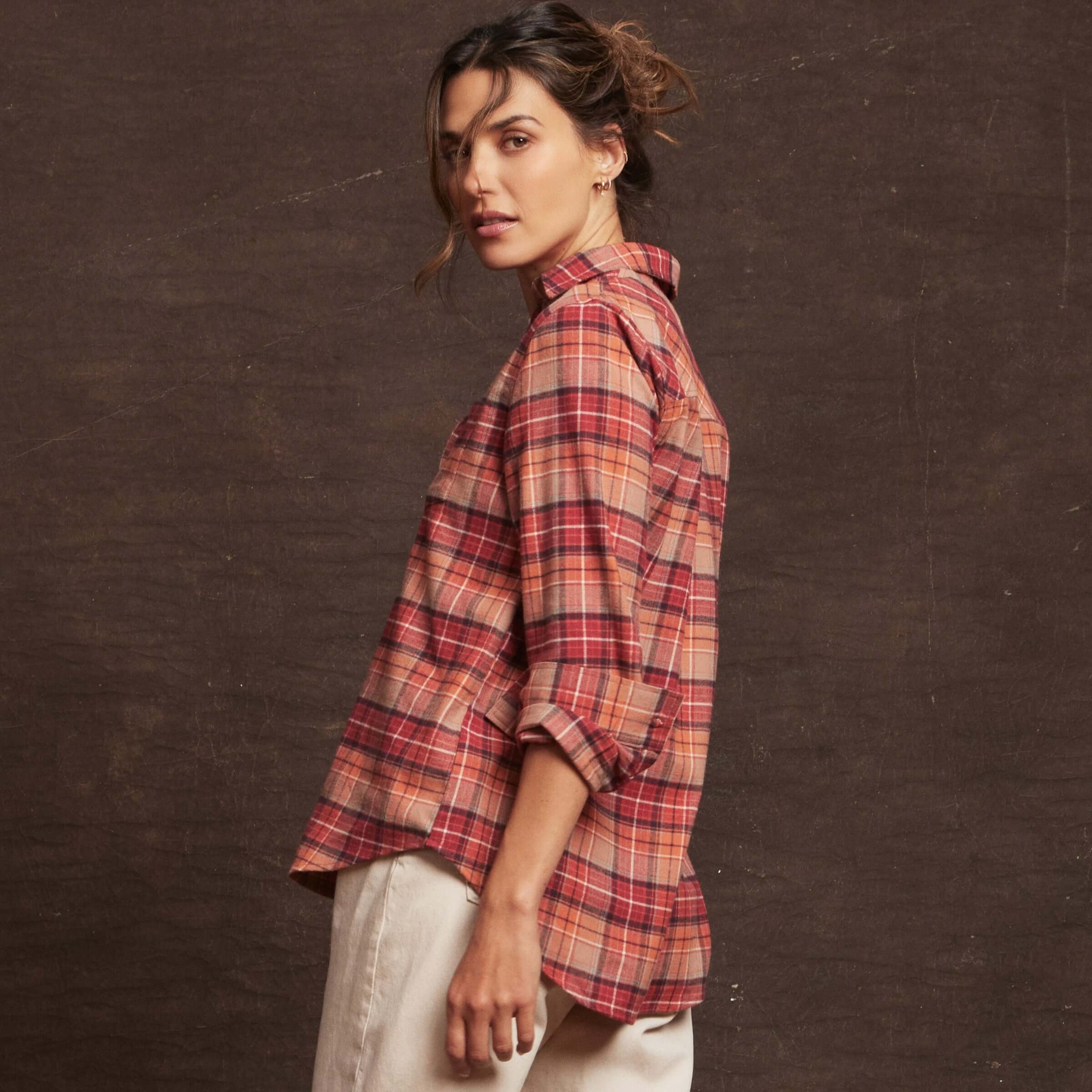 Women's orange stretch flannel shirt with a classic fit, notch V-neck, and rolled cuffs for a casual look.