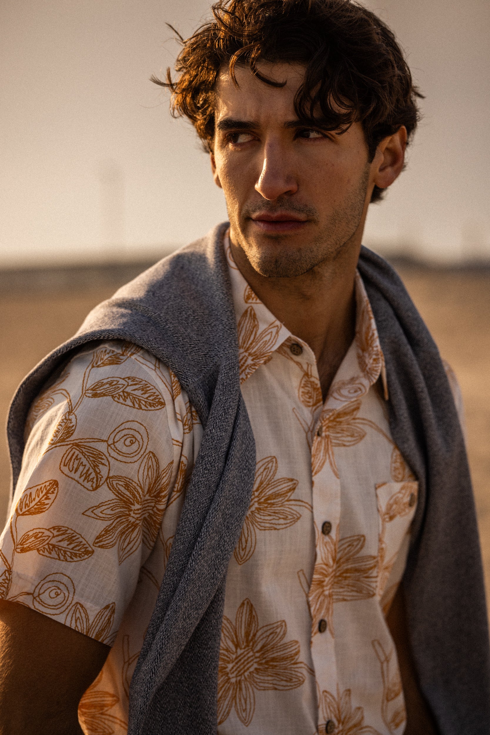 100% Cotton Linen-Texture Shirt in Sunrise featuring a floral pattern, worn by a model at sunset.