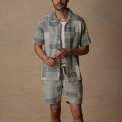 Man wearing a cream and navy jacquard short set, showcasing a relaxed style ideal for vacation.