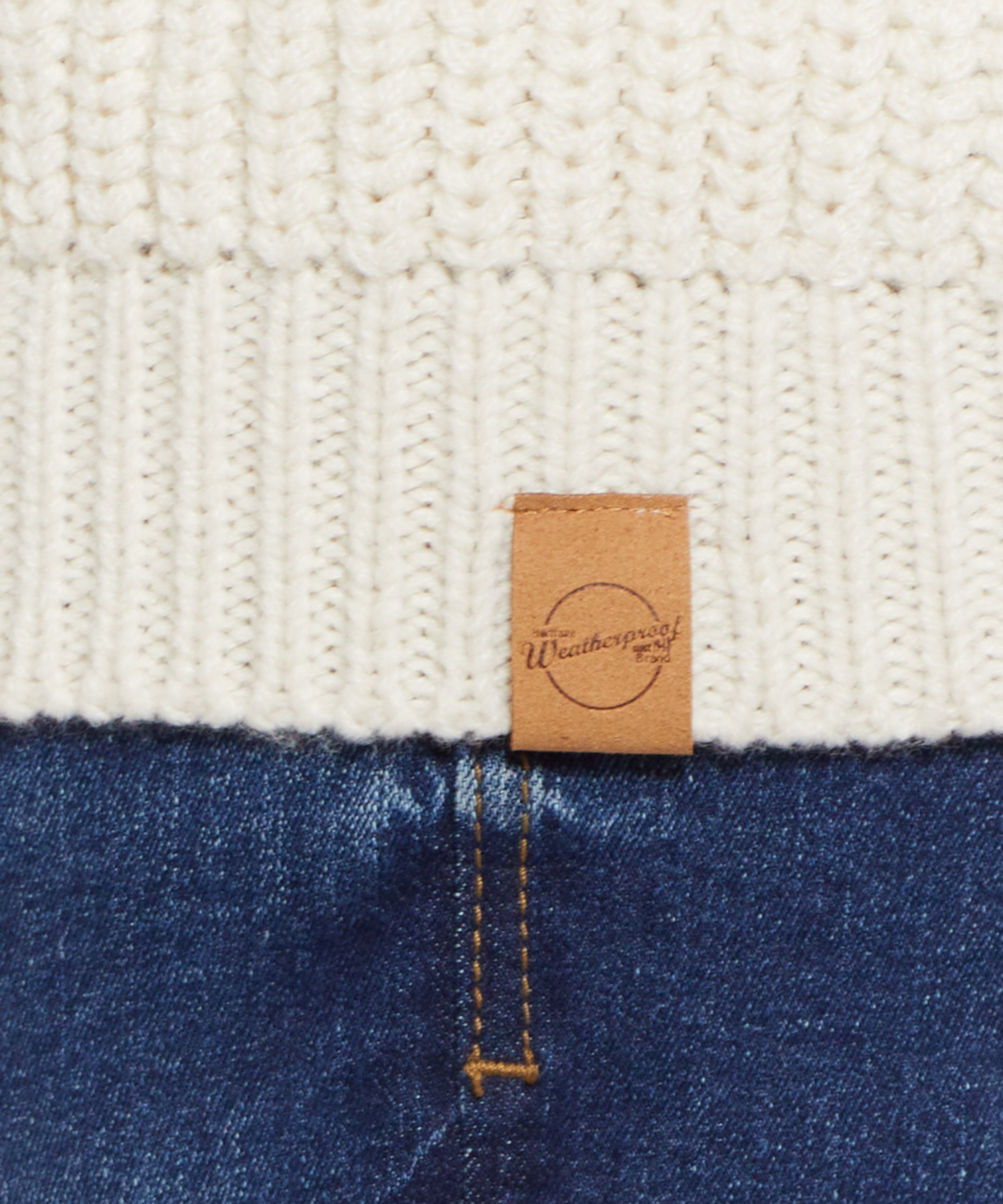CARDI W TOGGLES LINED in ECRU with close-up of texture and label on a warm cardigan and denim background.