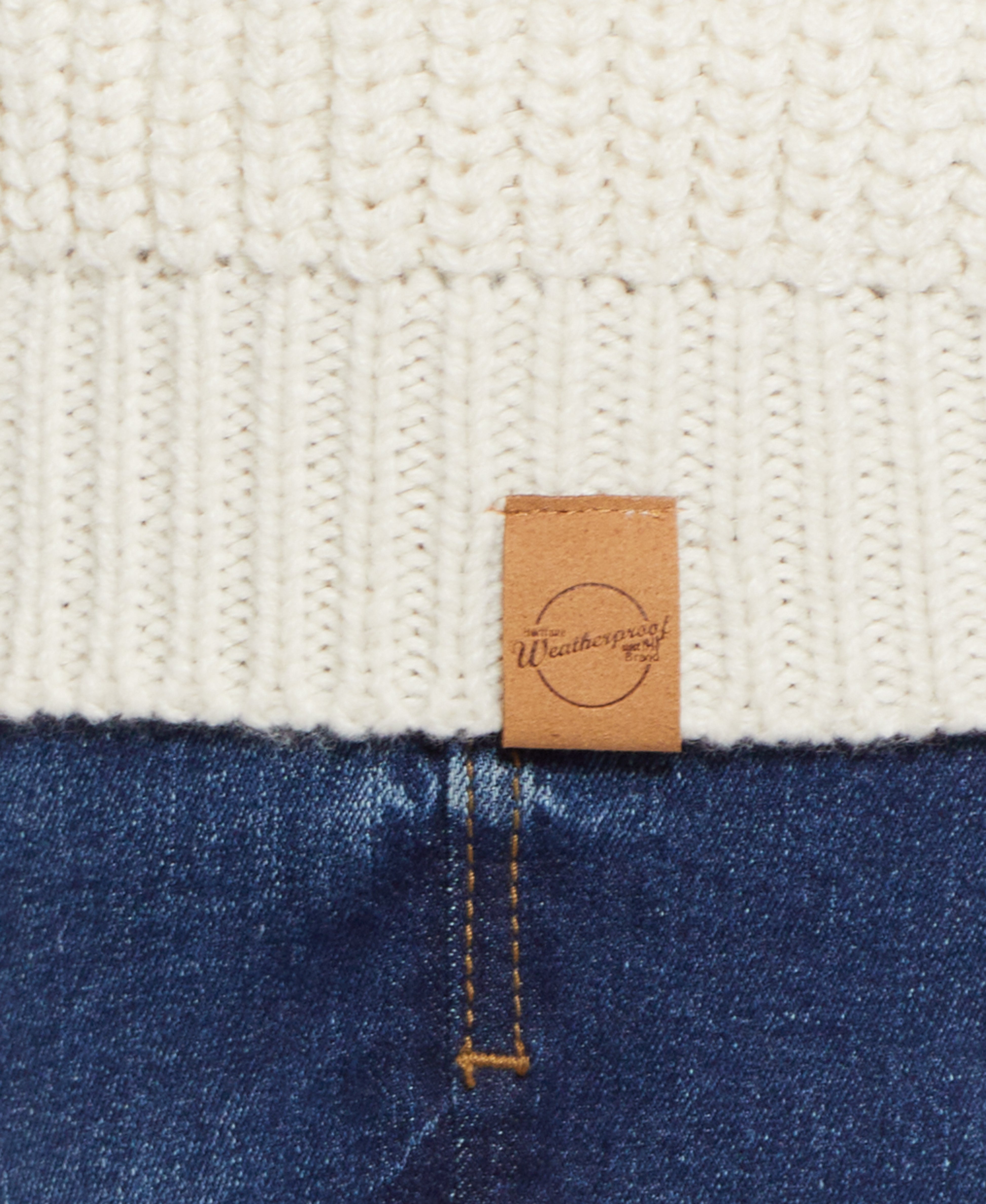 CARDI W TOGGLES LINED in ECRU with close-up of texture and label on a warm cardigan and denim background.