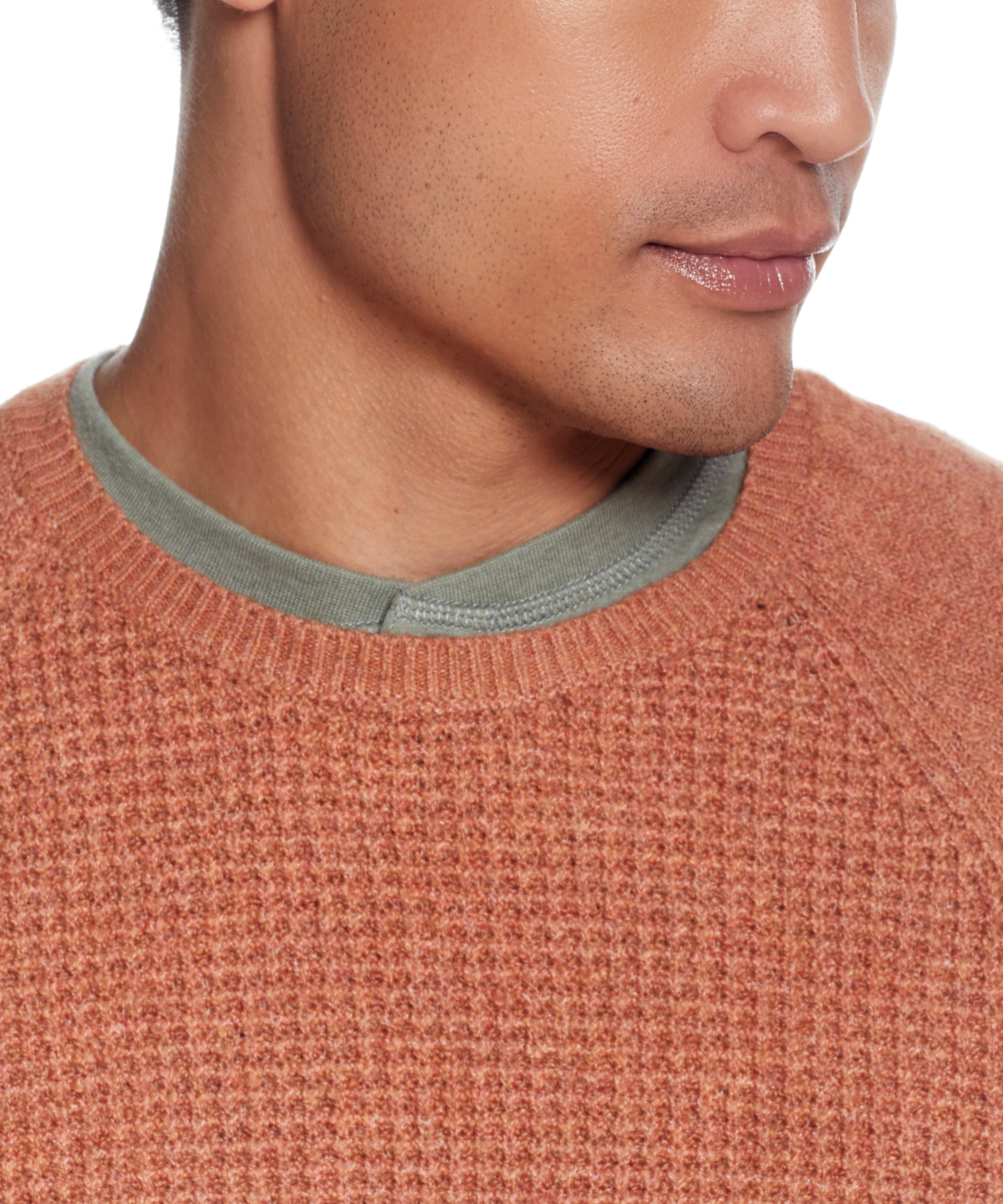 Close-up of a man wearing a Waffle Crewneck Sweater In Allspice, showcasing its textured design and crew neck.