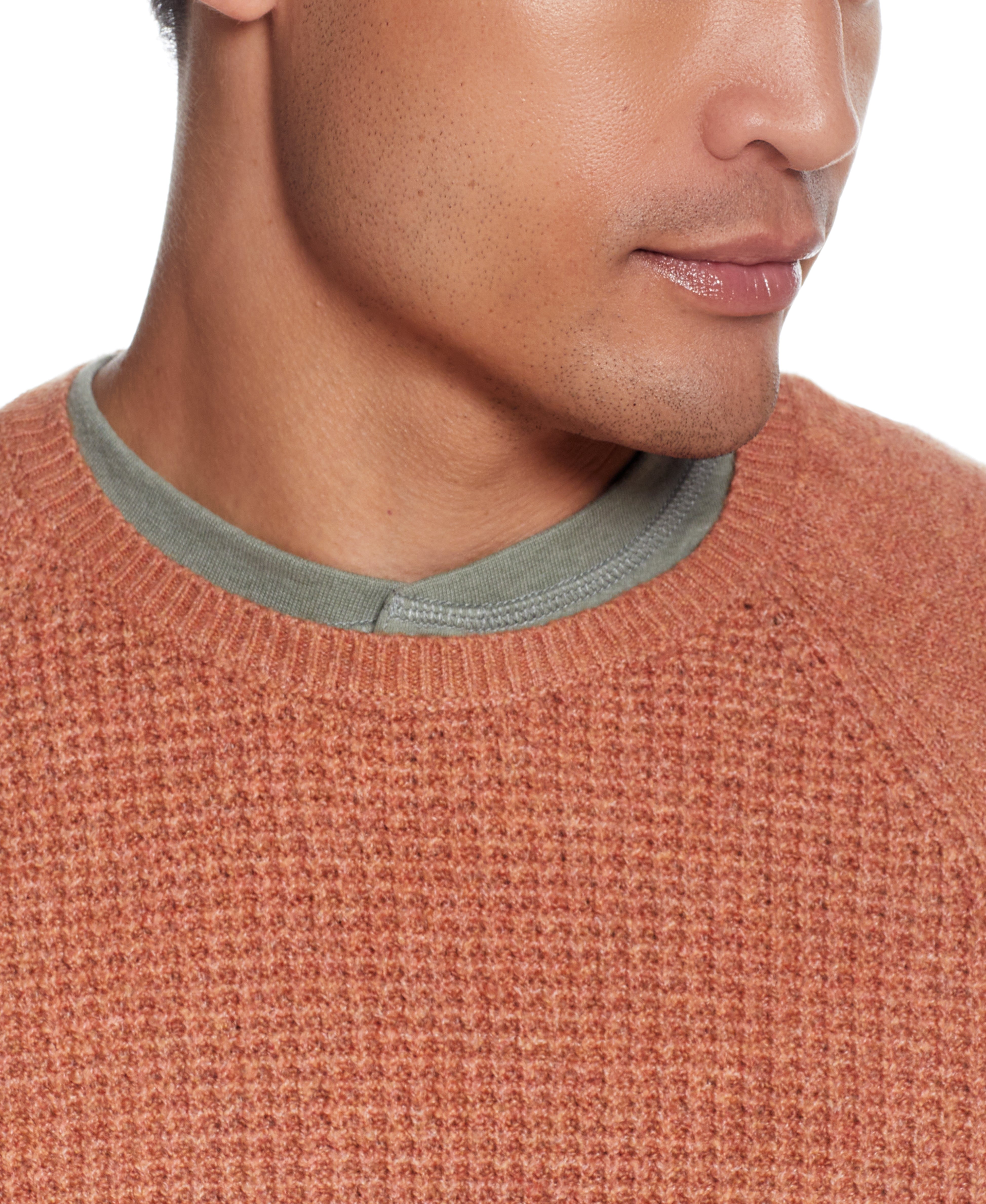 Close-up of a man wearing a Waffle Crewneck Sweater In Allspice, showcasing its textured design and crew neck.