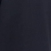 Cable Knit Quarter Zip Sweater In Black close-up detail showcasing the fabric texture and color.