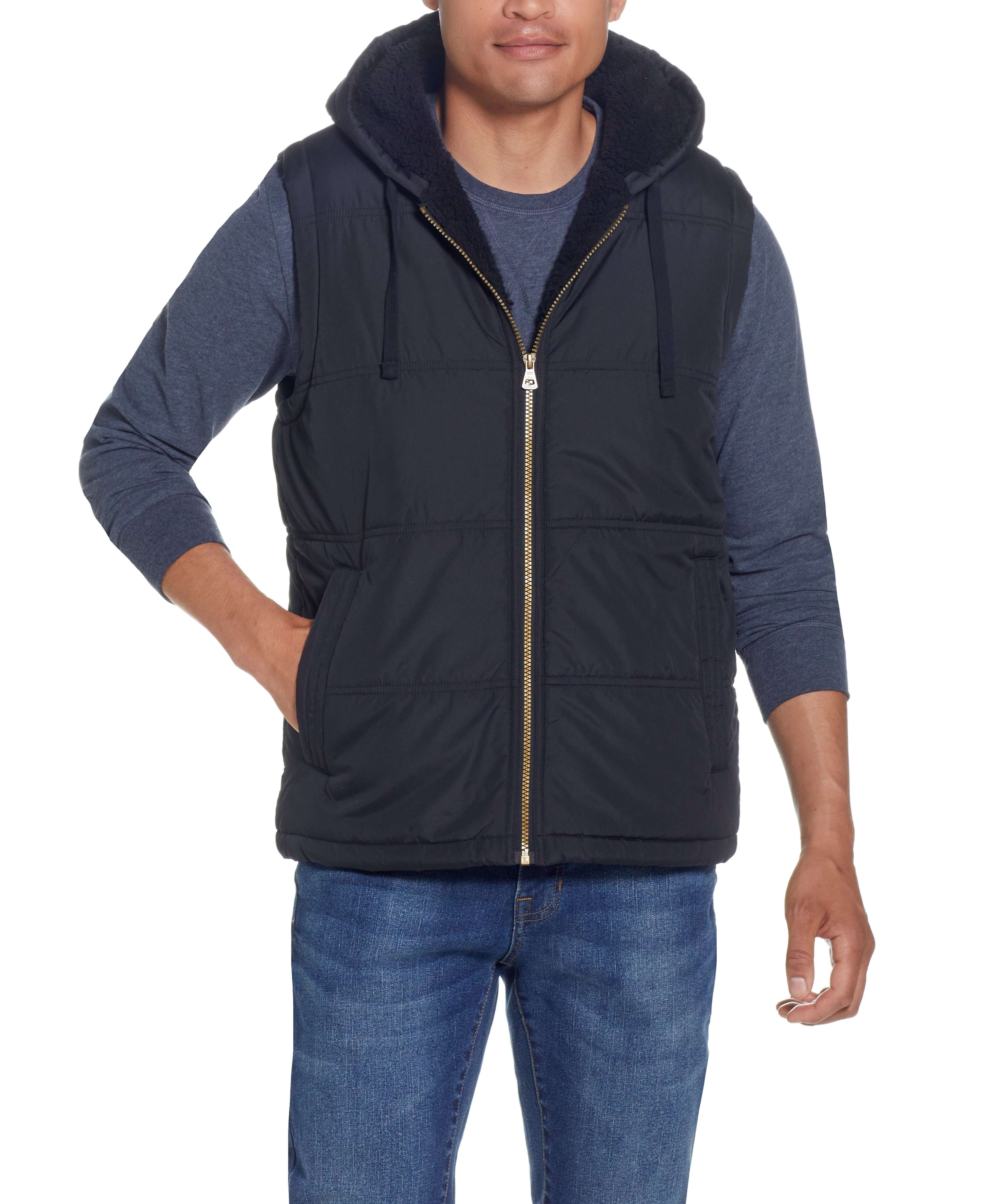 Sherpa Lined Hooded Puffer Vest In Black worn by model, featuring a drawcord hood and side pockets.