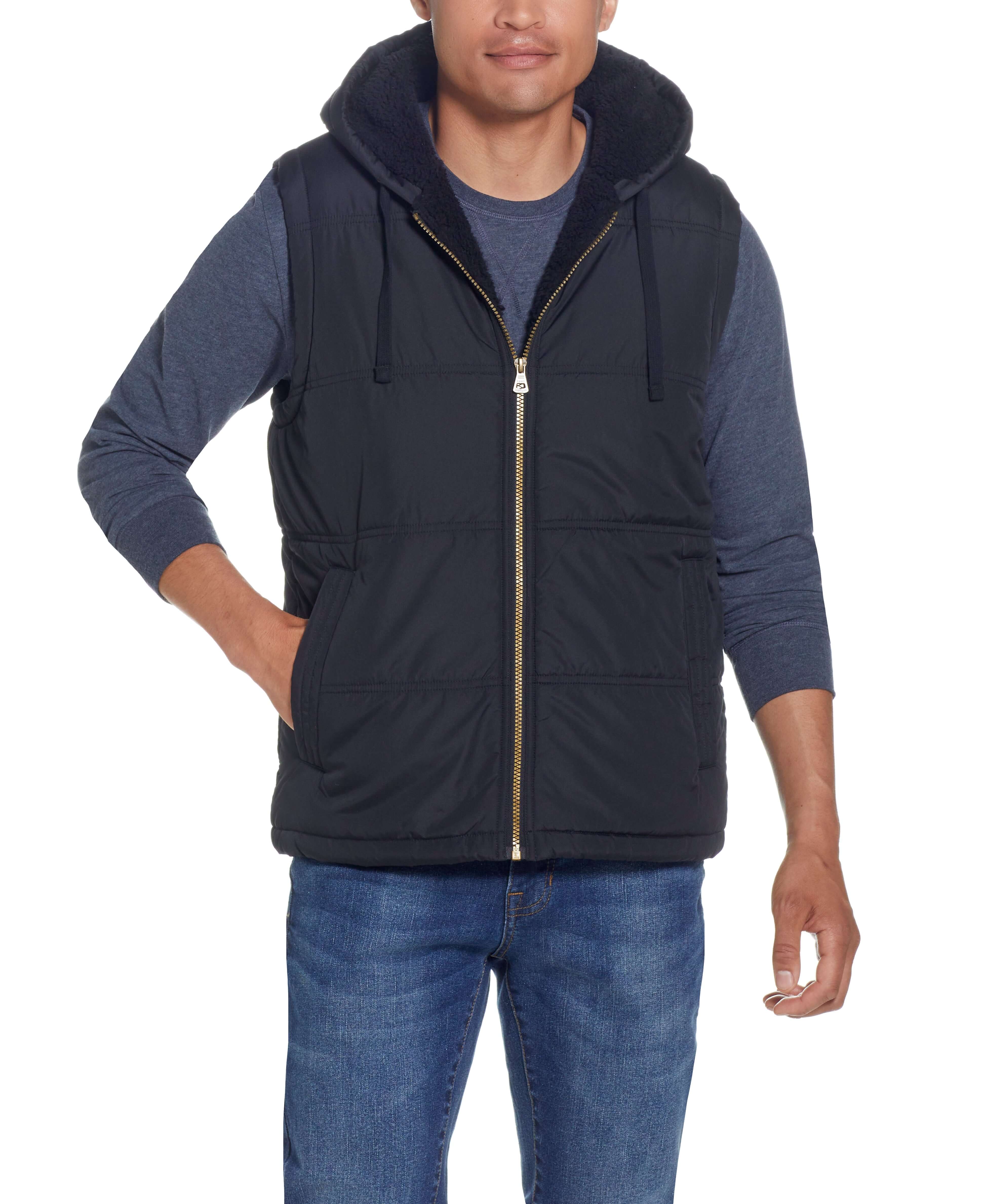 Sherpa Lined Hooded Puffer Vest In Black worn by model, featuring a drawcord hood and side pockets.