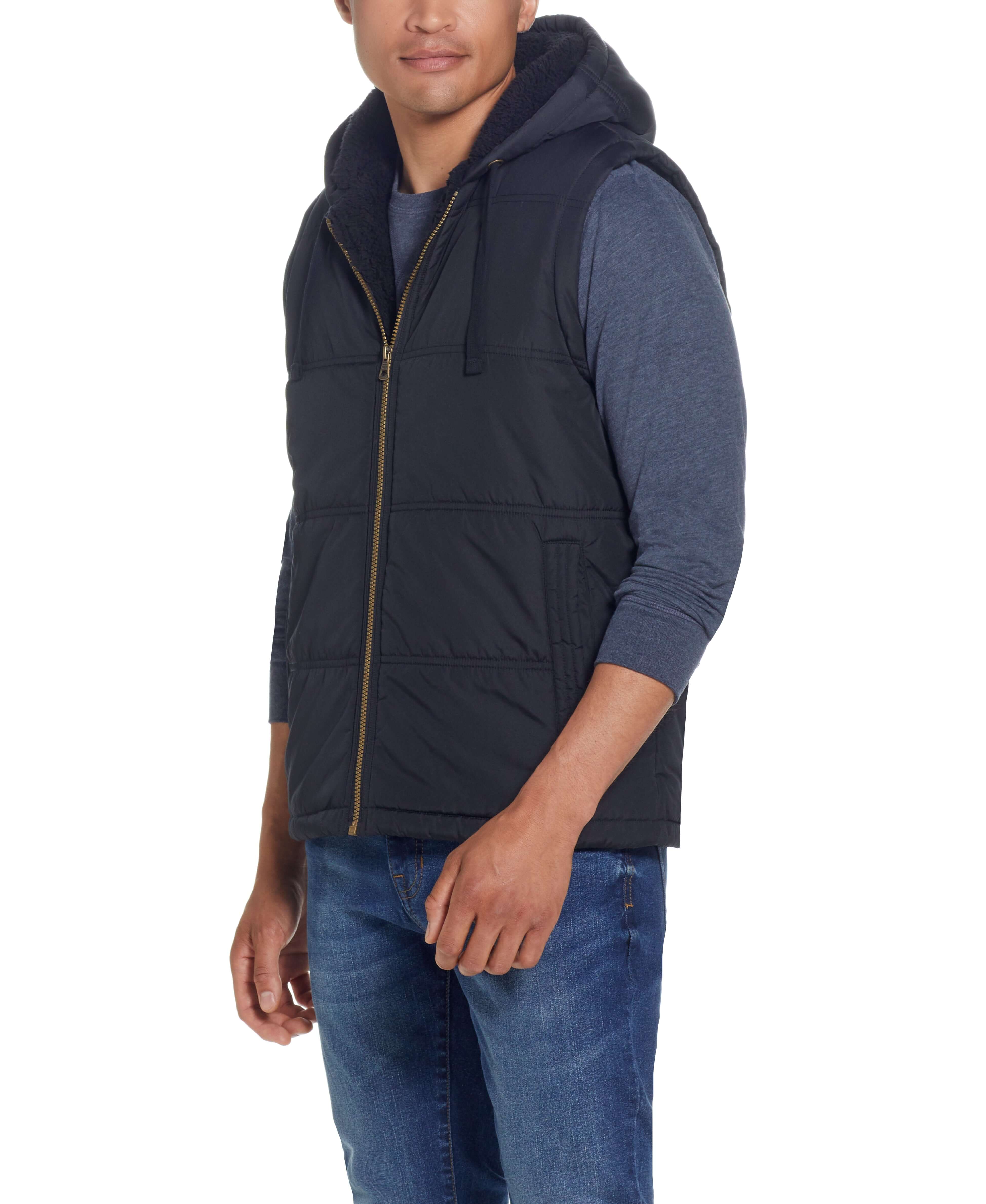 Sherpa Lined Hooded Puffer Vest In Black worn by a model, featuring a drawcord hood and side pockets.