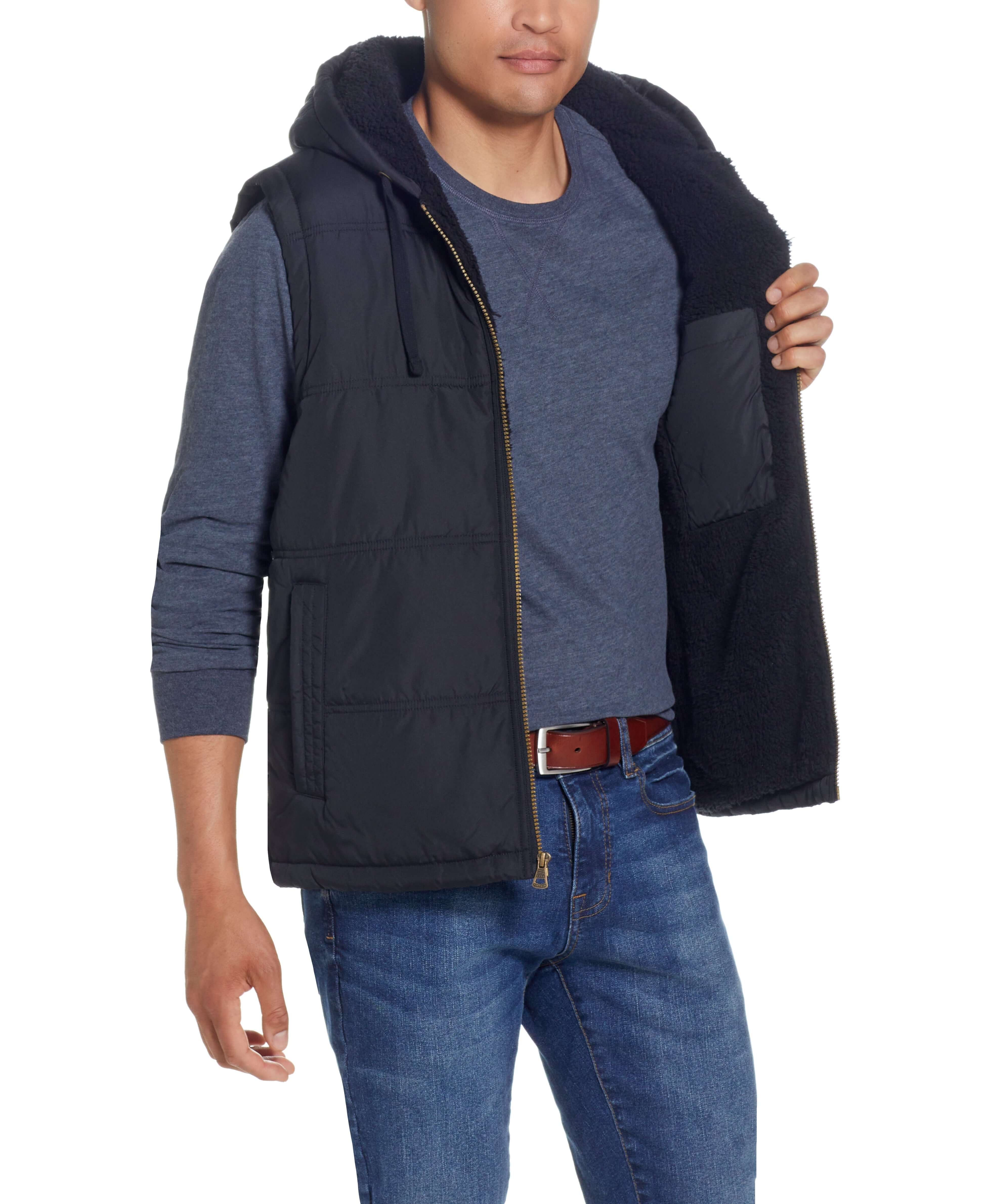 Sherpa Lined Hooded Puffer Vest In Black model showcasing the interior sherpa lining and drawcord hood.