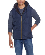 Sherpa Lined Hooded Puffer Vest In Dark Sapphire on model, showcasing cozy design and drawcord hood.