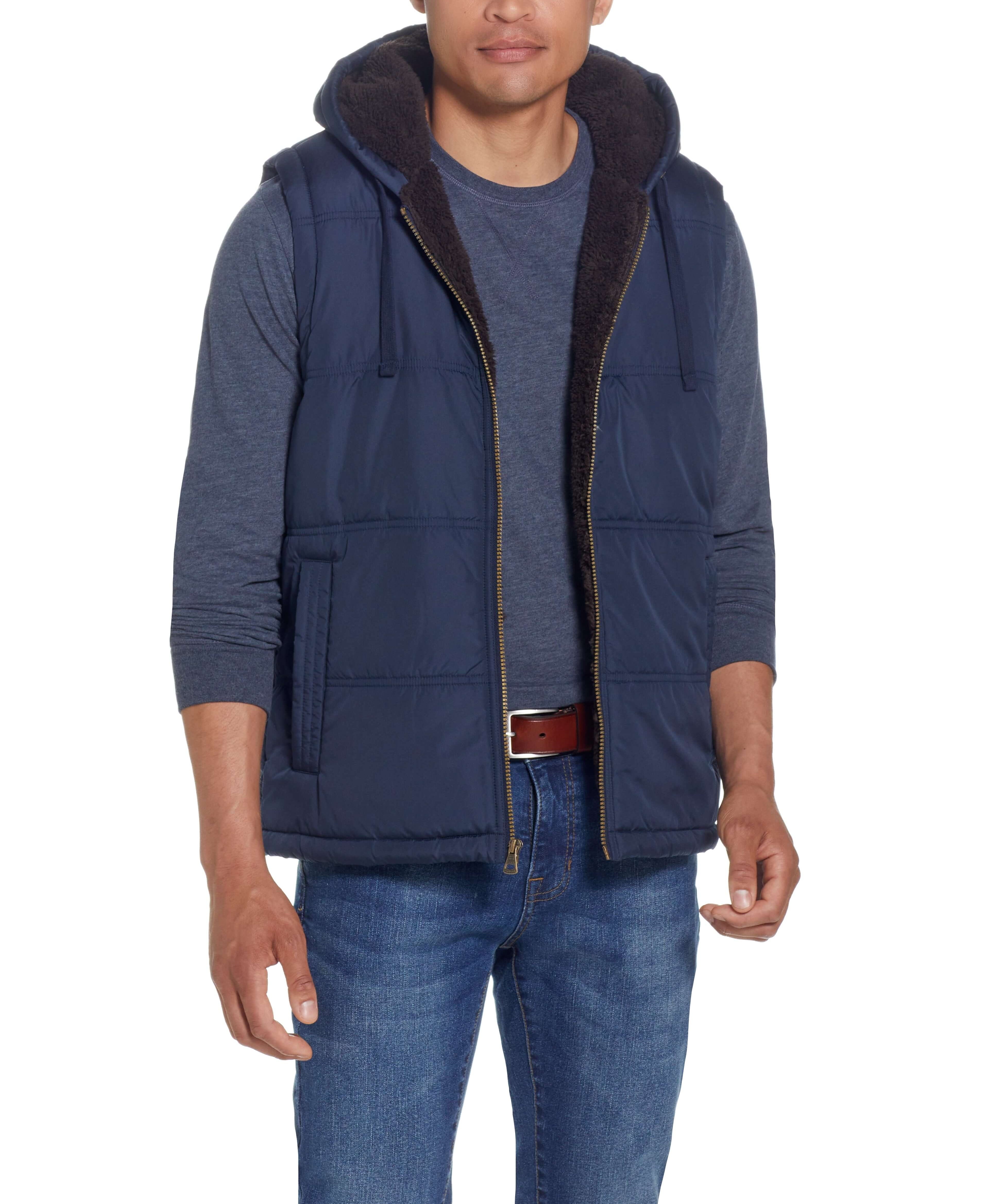 Sherpa Lined Hooded Puffer Vest In Dark Sapphire worn by a model, showcasing its cozy design and drawcord hood.