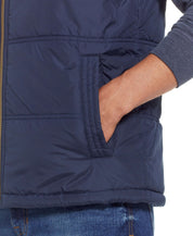 Close-up of the pocket on the Sherpa Lined Hooded Puffer Vest In Dark Sapphire showcasing its cozy design.