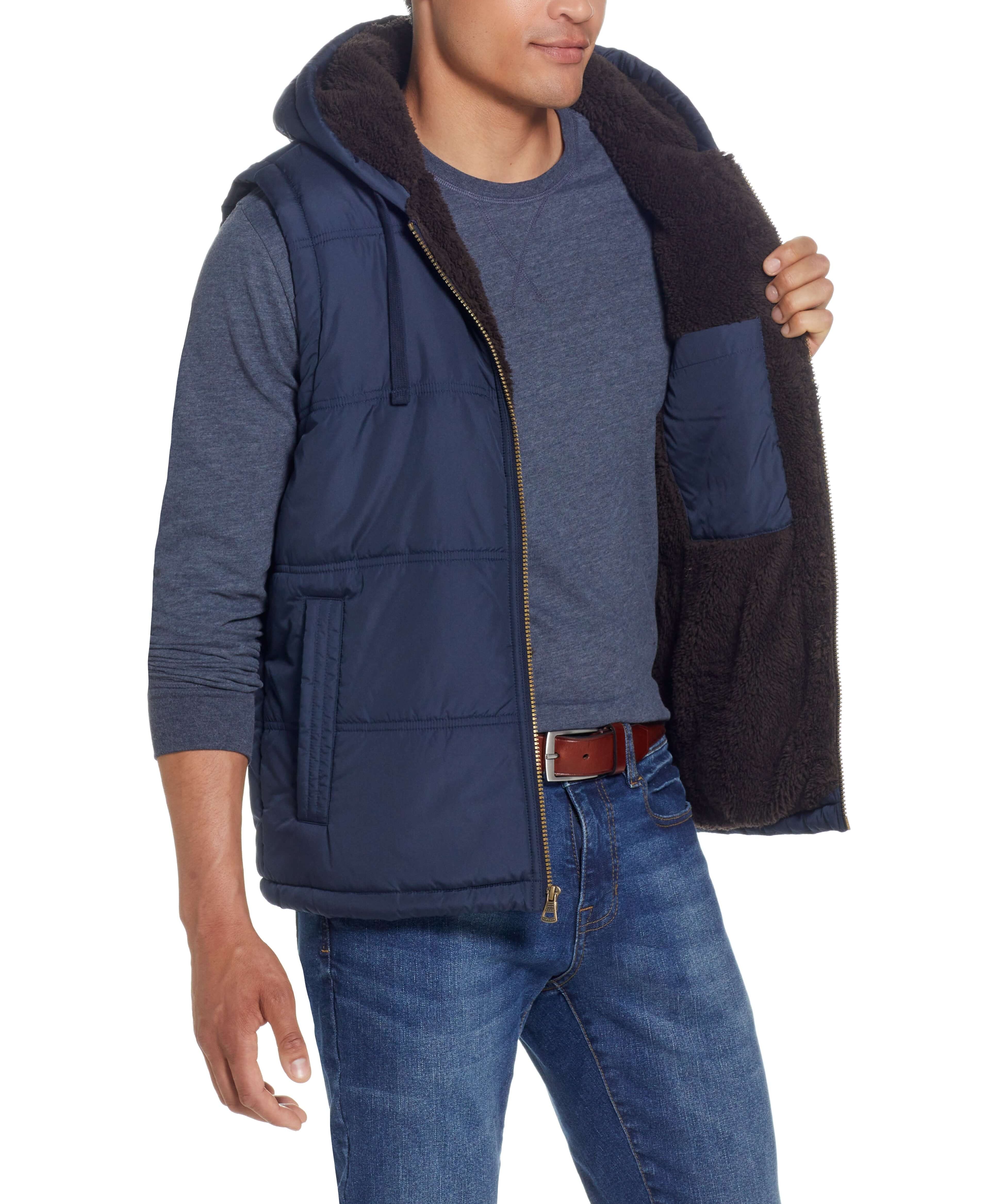 Sherpa Lined Hooded Puffer Vest In Dark Sapphire worn by a model showing cozy sherpa lining and side pockets.